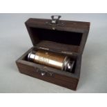 A small brass marine telescope in box.