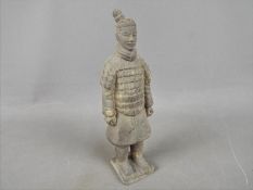 A reproduction Chinese terracotta warrior figure, approximately 21.