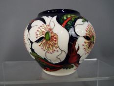 Moorcroft Pottery - a globular vase decorated in the Wayside Rambler pattern,