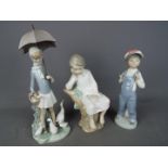 Lladro - Three Lladro figurines, largest approximately 28 cm (h).