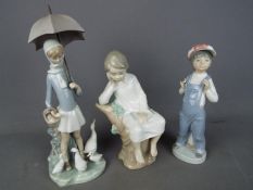 Lladro - Three Lladro figurines, largest approximately 28 cm (h).