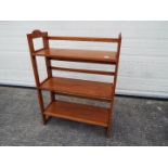 A vintage folding bookcase with three shelves,