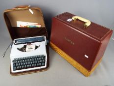 A vintage Singer 185K sewing machine in case and an Imperial portable typewriter, also cased.