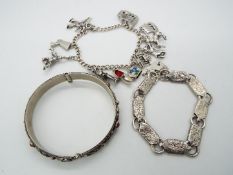 A charm bracelet with eleven continental charms, variously stamped 800, 835 etc,