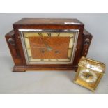 An oak cased mantel clock with Roman numerals to the dial,