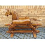A good quality carved wood rocking horse on gliders,