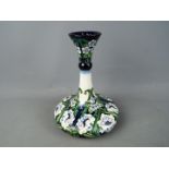 Moorcroft Pottery - a large vase with slender flared stem decorated in a floral pattern, 25 cm (h),