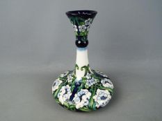 Moorcroft Pottery - a large vase with slender flared stem decorated in a floral pattern, 25 cm (h),
