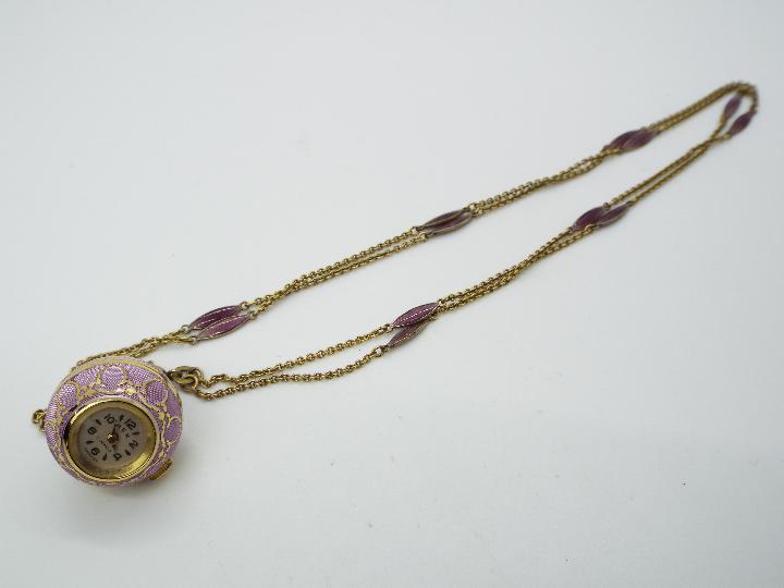 A Rex pendant globe watch, lilac toned body with gilt metal detailing, 17 jewel Swiss movement,
