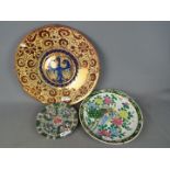 A large wall hanging charger, approximately 44 cm (d) and two Oriental plates.