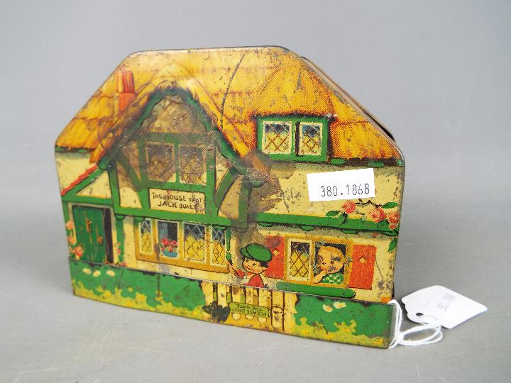 An early 20th century MacFarlane Lang & Co biscuit tin in the form of a cottage,