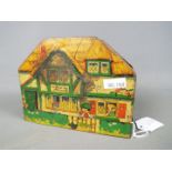An early 20th century MacFarlane Lang & Co biscuit tin in the form of a cottage,