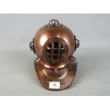 A metal reproduction of a diver's helmet,