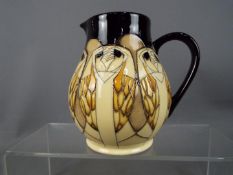 Moorcroft Pottery - a water jug decorated with Tengu Owls,