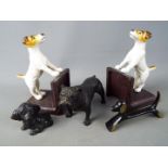 A pair of cast iron bookends in the form of dogs, cast metal model of a bulldog and similar.