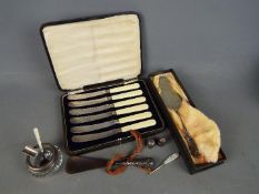 A collection of silver items to include hallmarked thimbles, silver handled shoe horn,