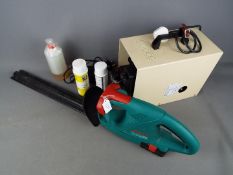 A Bosch AHS 41ACCU hedge trimmer and a Conopois air compressor.