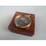 A brass compass marked 'Royal Navy' in box.