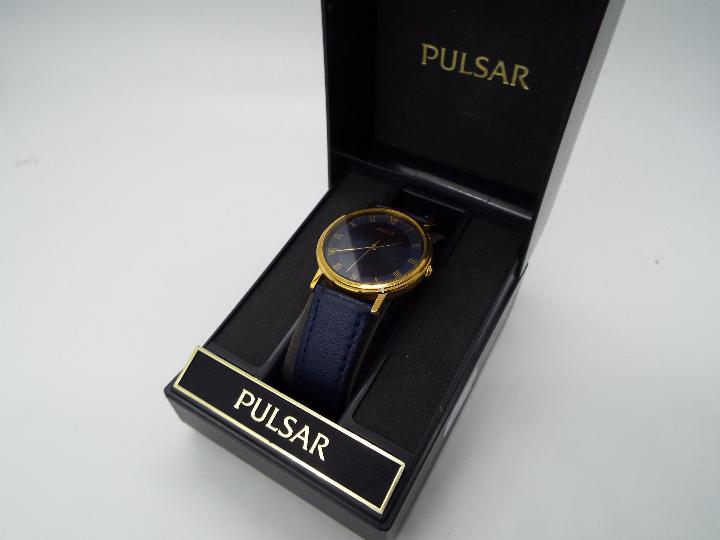 A gentleman's Pulsar wristwatch, Roman numerals to a blue dial, on blue leather strap, boxed.