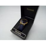 A gentleman's Pulsar wristwatch, Roman numerals to a blue dial, on blue leather strap, boxed.