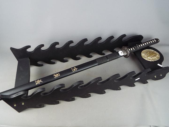 A reproduction Japanese sword with dragon decorated tsuba,
