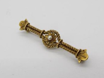 15ct gold - a 15ct gold bar brooch with a floral design set with pearl, stamped 15ct, approximate 4.
