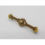 15ct gold - a 15ct gold bar brooch with a floral design set with pearl, stamped 15ct, approximate 4.