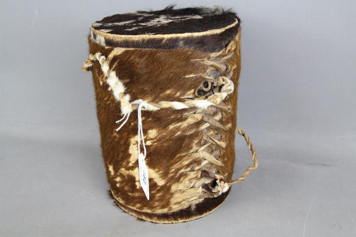 An animal skin drum and a painted tribal mask. - Image 4 of 4