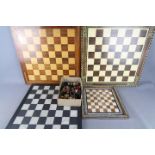 A quantity of assorted chess pieces and chess boards, largest board approximately 51 cm x 51 cm.