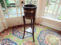 A 19th century coopered oak and brass bound barrel planter / plant stand torchere raised on shaped