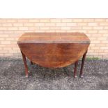 Gateleg Table - a George II oak gateleg table, the oval twin flap top above an end frieze drawer,