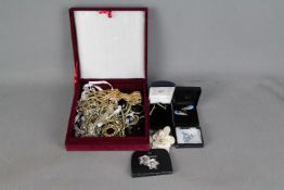 A velvet jewellery box containing a quantity of good quality evening jewellery to include brooches,