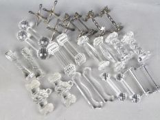 Twelve pairs of knife rests comprising glass examples including a Val St Lambert pair in the form