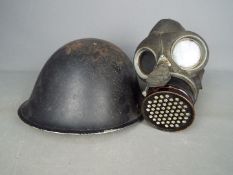 A World War Two (WWII) gas mask by L & B. R. Co and a British Mk IV 'Turtle' helmet.