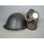 A World War Two (WWII) gas mask by L & B. R. Co and a British Mk IV 'Turtle' helmet.