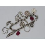 A silver charm bracelet with 14 charms Est £25 - £40