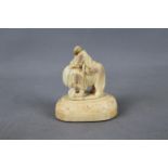 A small, early 20th century carving depicting an elephant and mahout on separate plinth,