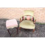 An upholstered armchair with mahogany frame, the supports terminating in casters,