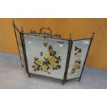 A mirrored triptych firescreen, each bevel edged plate hand painted with floral decoration,