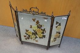 A mirrored triptych firescreen, each bevel edged plate hand painted with floral decoration,