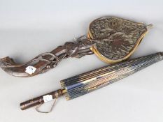 A set of Bellows intricately carved with foliate and fruit decoration and an Oriental parasol with