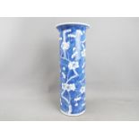 A large blue and white vase with flared rim, decorated with prunus, four character mark to the base,