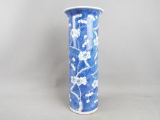 A large blue and white vase with flared rim, decorated with prunus, four character mark to the base,