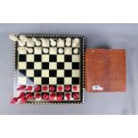 An early 20th century bone chess set with stained and natural pieces, king approximately 9 cm (h),