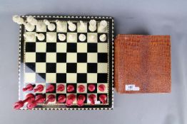 An early 20th century bone chess set with stained and natural pieces, king approximately 9 cm (h),