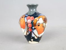Moorcroft Pottery - a Christmas solifleur vase decorated in the 'Brave Sir Robin' pattern,