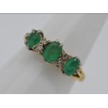 An 18ct gold, emerald and diamond set ring, size J + 1/2, approximately 3.2 grams all in.