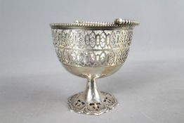 A silver pedestal bowl with pierced decoration and swing handle, Mappin, standing 11.