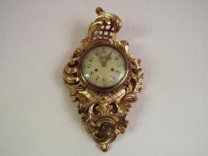 A Swedish 20th century Rococo-styled carved and gilded wood-cased cartel wall clock,