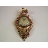 A Swedish 20th century Rococo-styled carved and gilded wood-cased cartel wall clock,